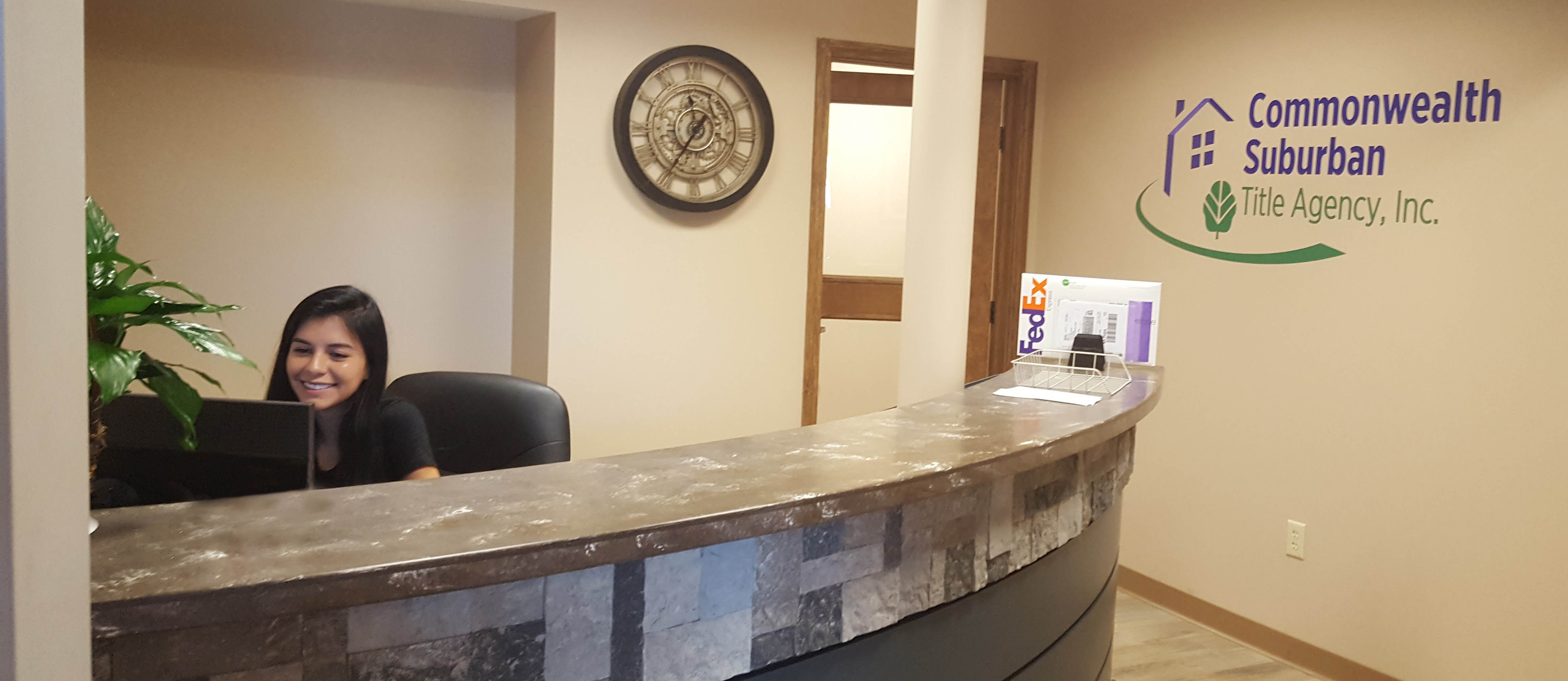 Receptionist at desk in the Commonwealth Suburban Title Agency's Canfield Office